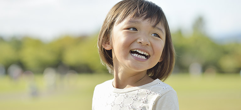 Asian girl smiling outside