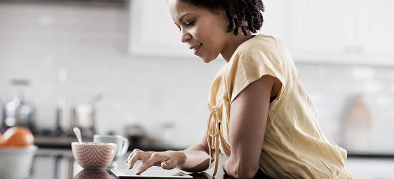 Woman on a tablet in the kitchen